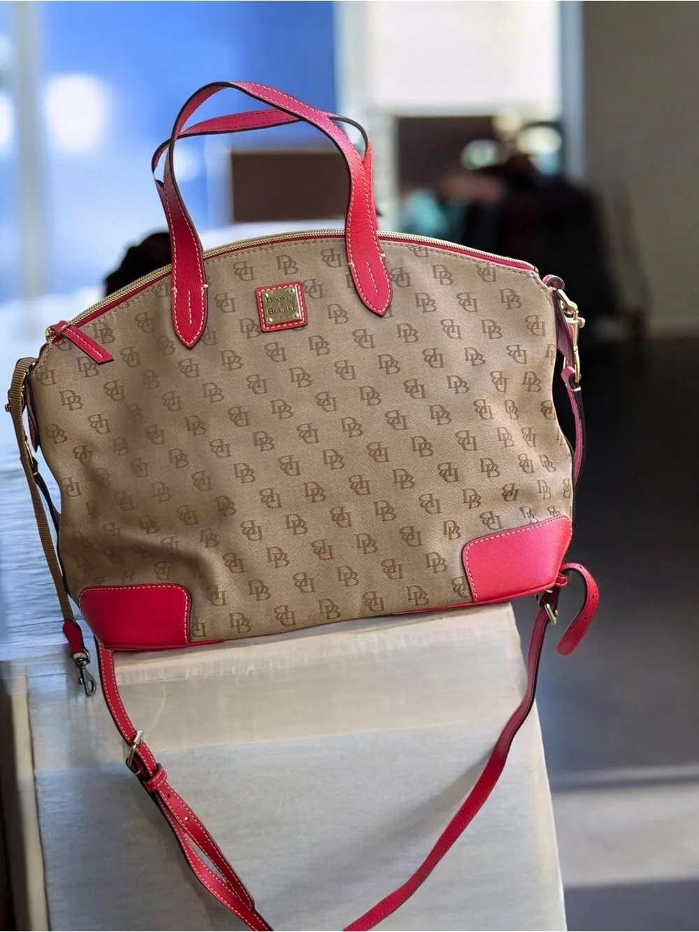 Dooney & Bourke Signature monogram satchel features vibrant pink leather trim